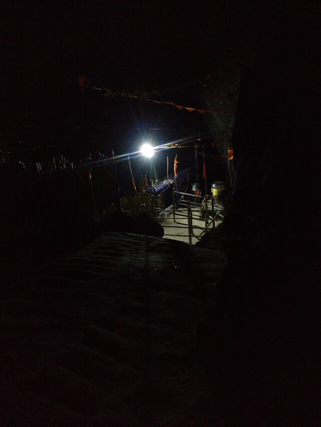 Picture taken at night, showing a part of the temple. Mostly dark. A CFL illuminates some part of the temple, but nothing much visible